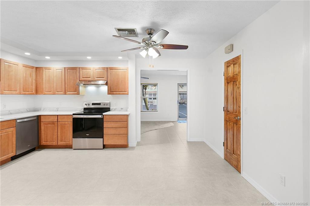 50 Southwest Blackburn Terrace, Unit 8 Stuart, FL 34997 - Photo 23 of 42 a kitchen with a refrigerator and a sink