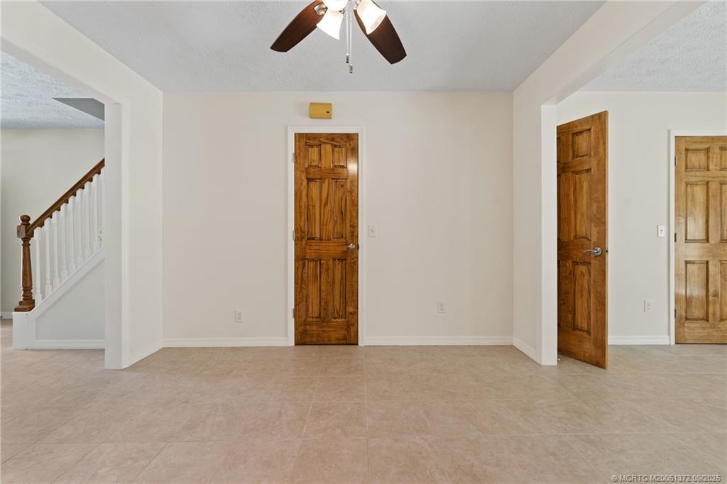 50 Southwest Blackburn Terrace, Unit 8 Stuart, FL 34997 - Photo 24 of 42 an empty room with closet and chandelier fan
