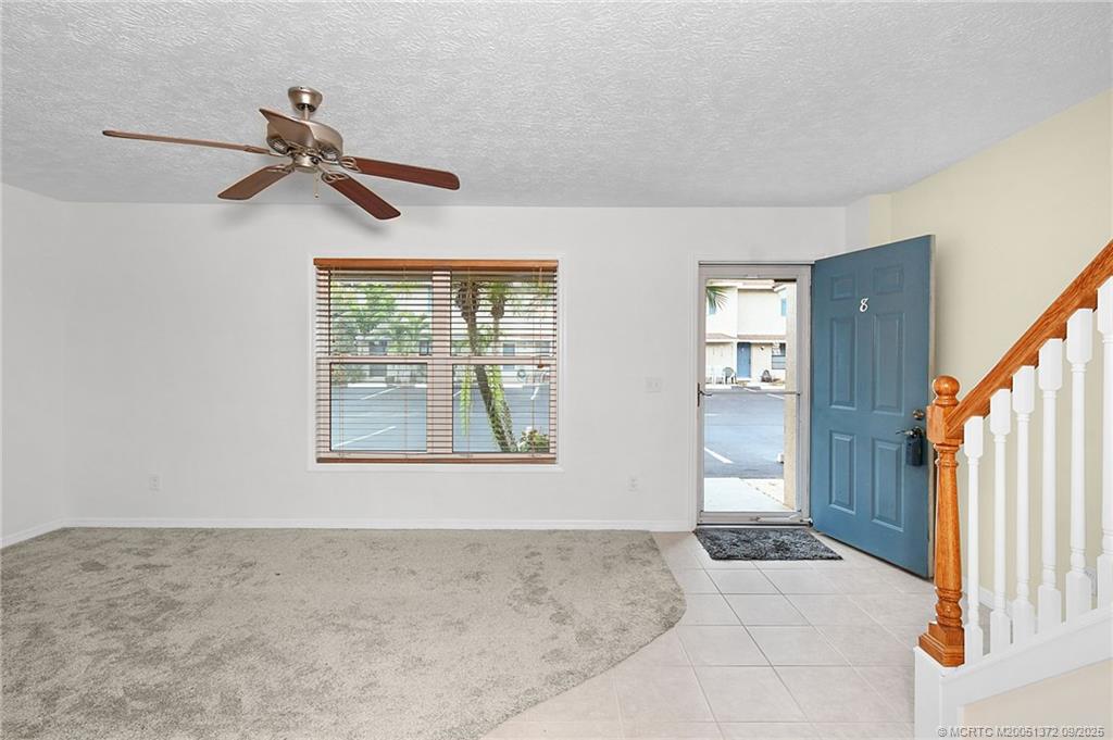50 Southwest Blackburn Terrace, Unit 8 Stuart, FL 34997 - Photo 3 of 42 wooden floor in an empty room with a window