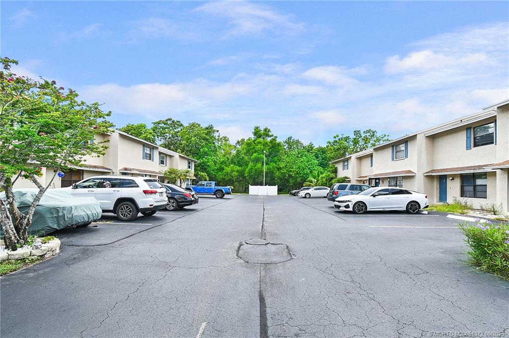 50 Southwest Blackburn Terrace, Unit 8 Stuart, FL 34997 - Photo 35 of 42 a view of a cars parked in front of a house