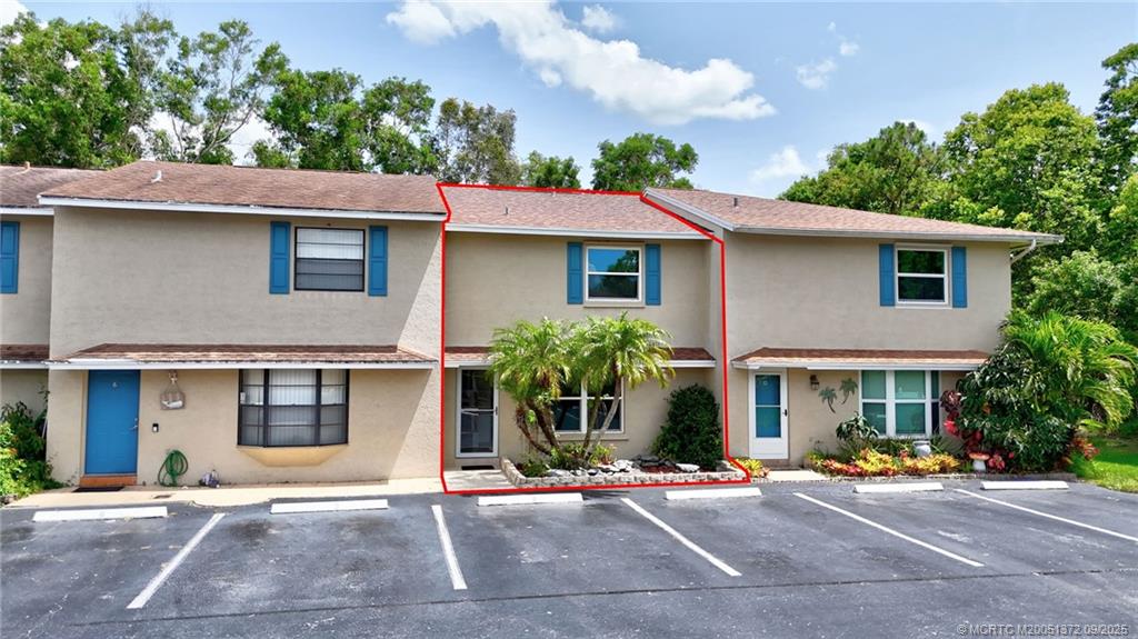 50 Southwest Blackburn Terrace, Unit 8 Stuart, FL 34997 - Photo 42 of 42 a front view of a house with garage
