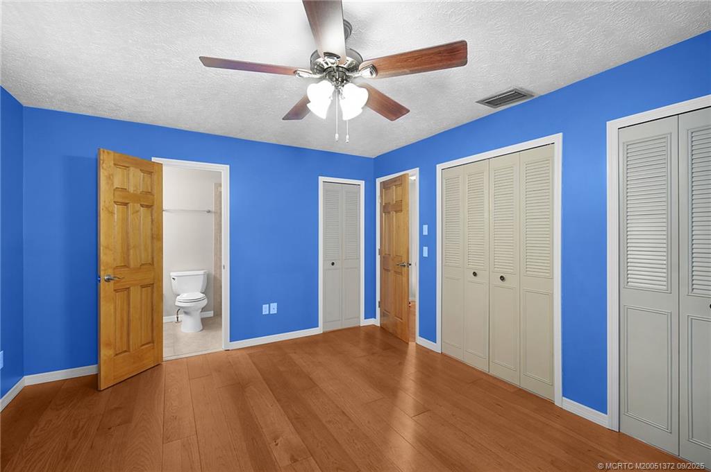 50 Southwest Blackburn Terrace, Unit 8 Stuart, FL 34997 - Photo 6 of 42 a view of a livingroom with a chandelier fan and a bathroom