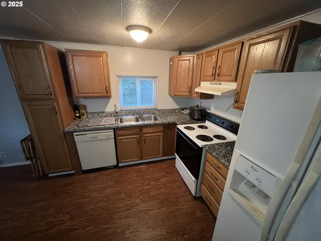 a stove top oven sitting inside of a kitchen