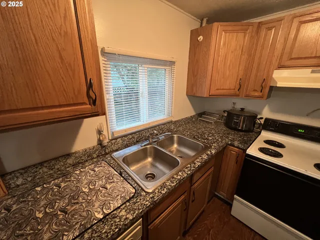 a kitchen with a stove and a refrigerator