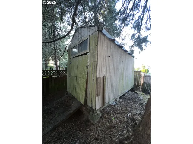 a view of a swimming pool with a patio and plants