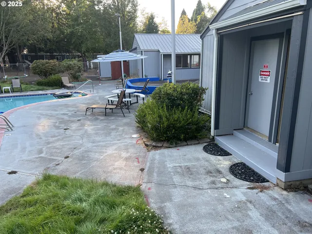a view of a house with backyard and the trees