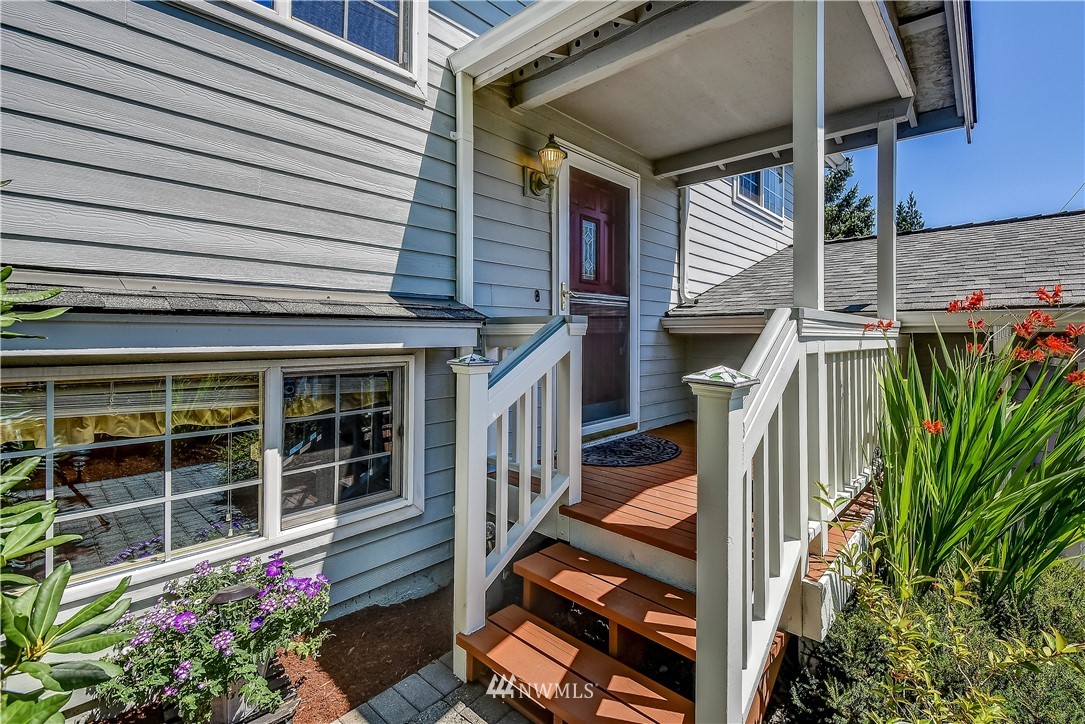 417 212th Street Southwest Bothell, WA 98021 - Photo 2 of 28 a front view of a house with a garden