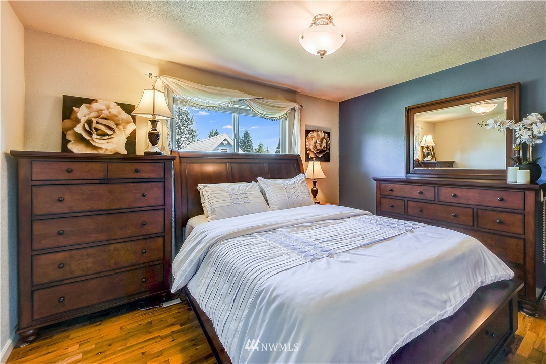 417 212th Street Southwest Bothell, WA 98021 - Photo 11 of 28 a bedroom with a bed and a flat screen tv