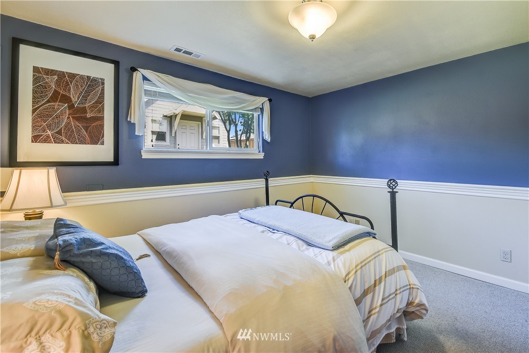 417 212th Street Southwest Bothell, WA 98021 - Photo 15 of 28 a bedroom with a bed and wall painting