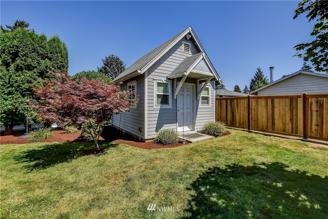 417 212th Street Southwest Bothell, WA 98021 - Photo 22 of 28 a front view of a house with garden