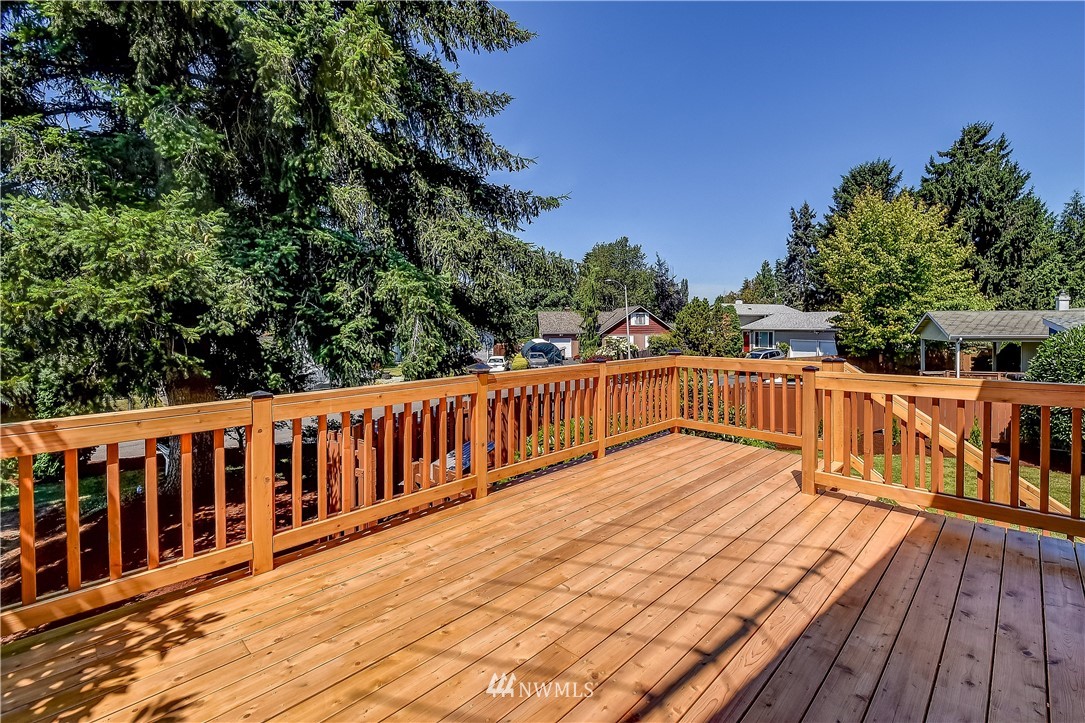 417 212th Street Southwest Bothell, WA 98021 - Photo 7 of 28 a balcony with wooden floor and fence