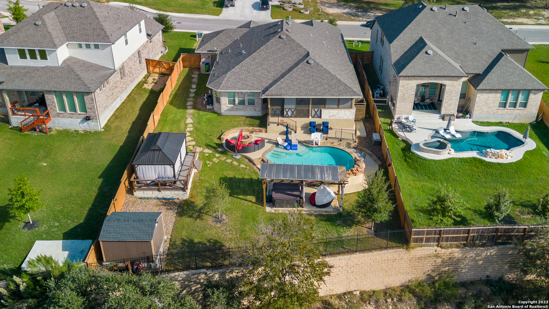 an aerial view of a house with swimming pool garden and patio