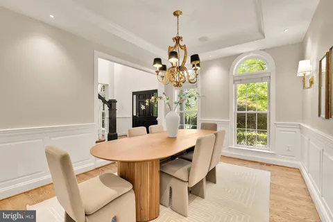 a view of a dining room with furniture and a chandelier