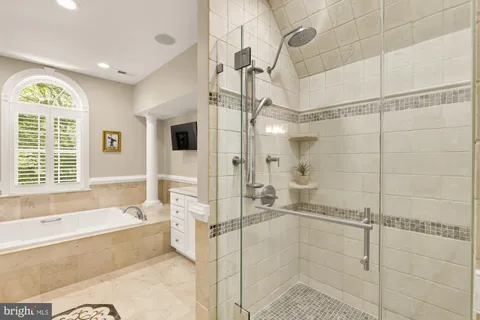 a bathroom with a bathtub and a shower