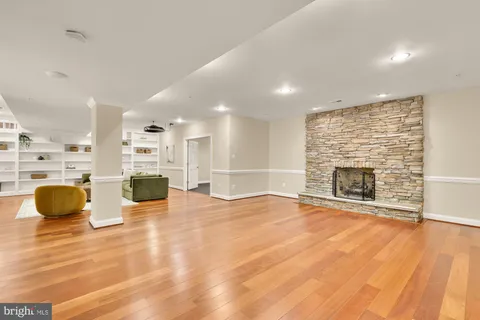 a view of an empty room with a fireplace and window