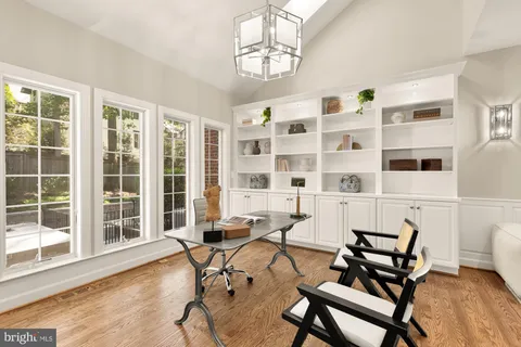 a view of a work space with furniture and windows