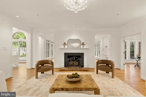 a living room with furniture a fireplace and a large window
