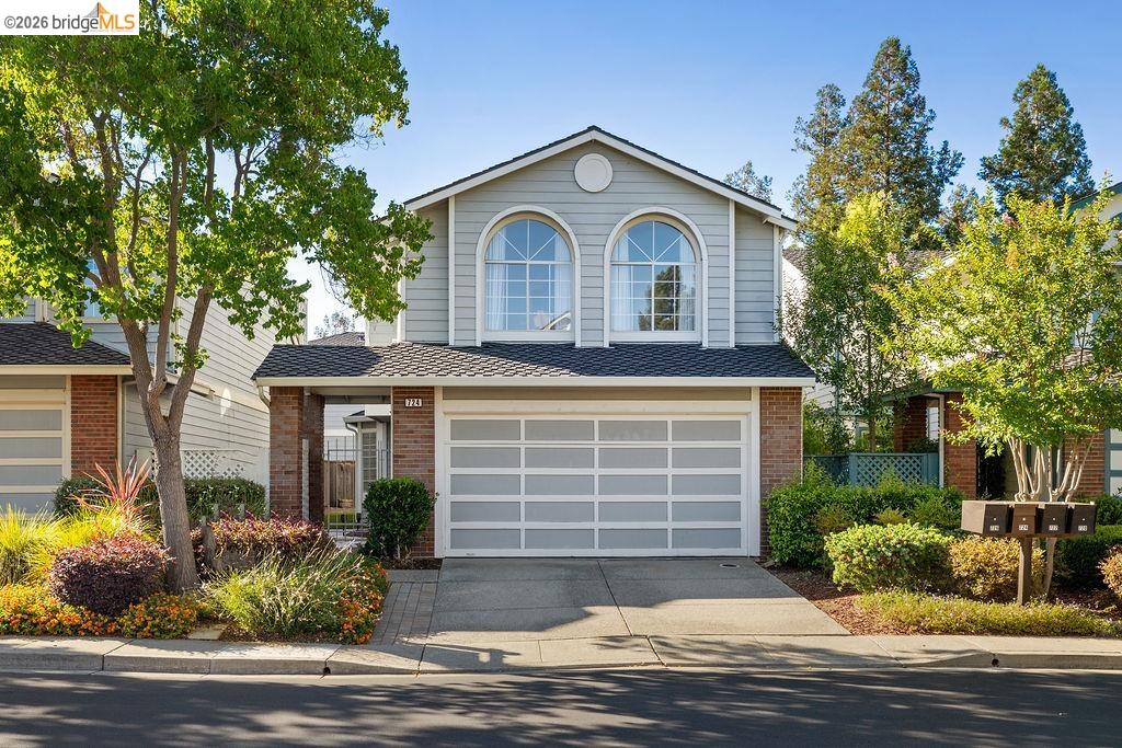 724 Winterside Circle San Ramon, CA 94583 - Photo 1 of 43 Two-story residence featuring light gray siding with brick accents, an attached garage, two arched windows, and mature landscaping