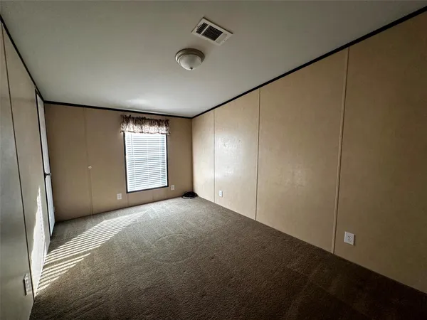a view of an empty room with windows