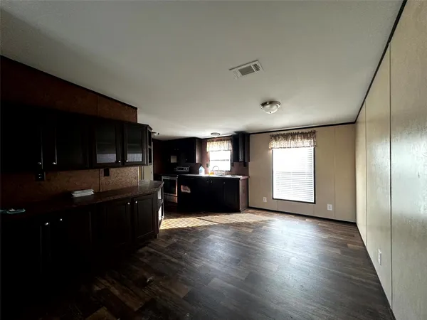 a view of kitchen with microwave refrigerator and cabinets