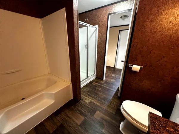 a bathroom with a toilet and a tub