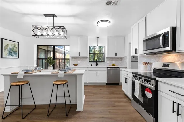 a kitchen with a sink stove and microwave