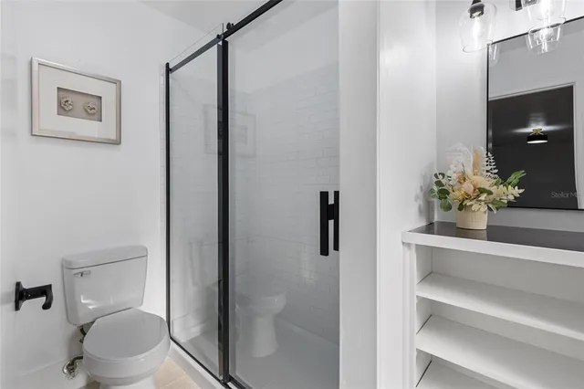 a white toilet sitting next to a bathroom sink
