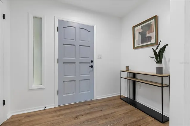 a view of empty room with wooden floor