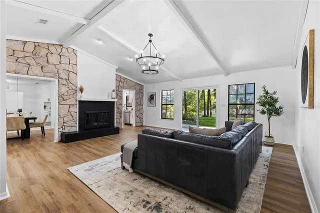 a living room with furniture flat screen tv and a fireplace