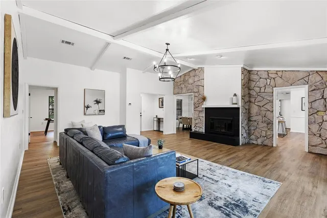 a living room with furniture a fireplace and a flat screen tv