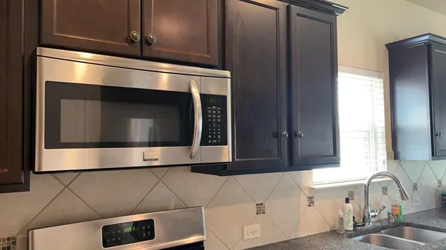 a bathroom with a sink and a microwave