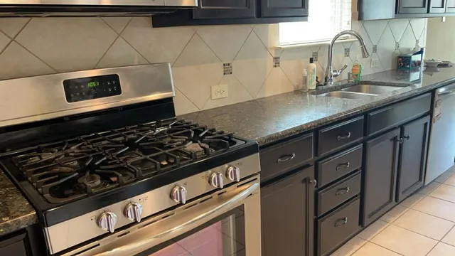 a close view of a stove a microwave and cabinets