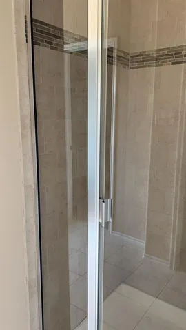 a bathroom with a glass door shower
