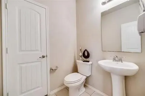 a bathroom with a sink toilet and a mirror