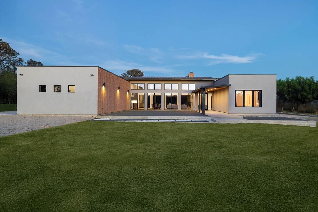 a front view of a house with a garden