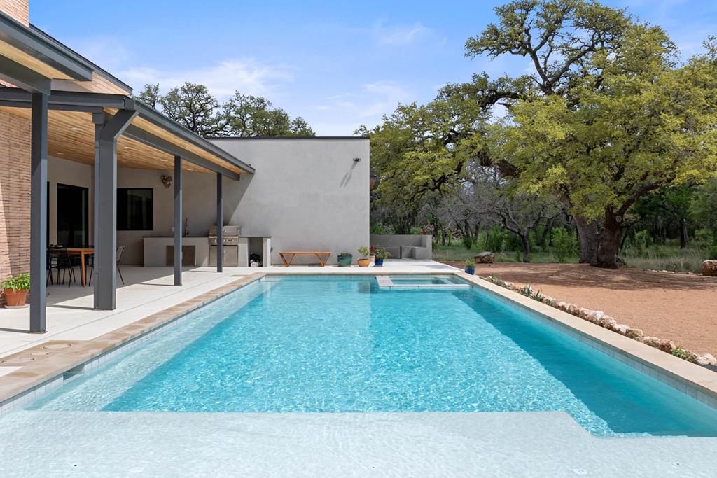 444 Klein Road Stonewall, TX 78671 - Photo 26 of 55 a view of a backyard with swimming pool
