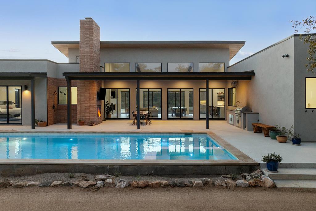 444 Klein Road Stonewall, TX 78671 - Photo 3 of 55 a living room with a lots of furniture and a floor to ceiling window