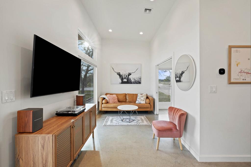 444 Klein Road Stonewall, TX 78671 - Photo 40 of 55 a living room with furniture and a flat screen tv