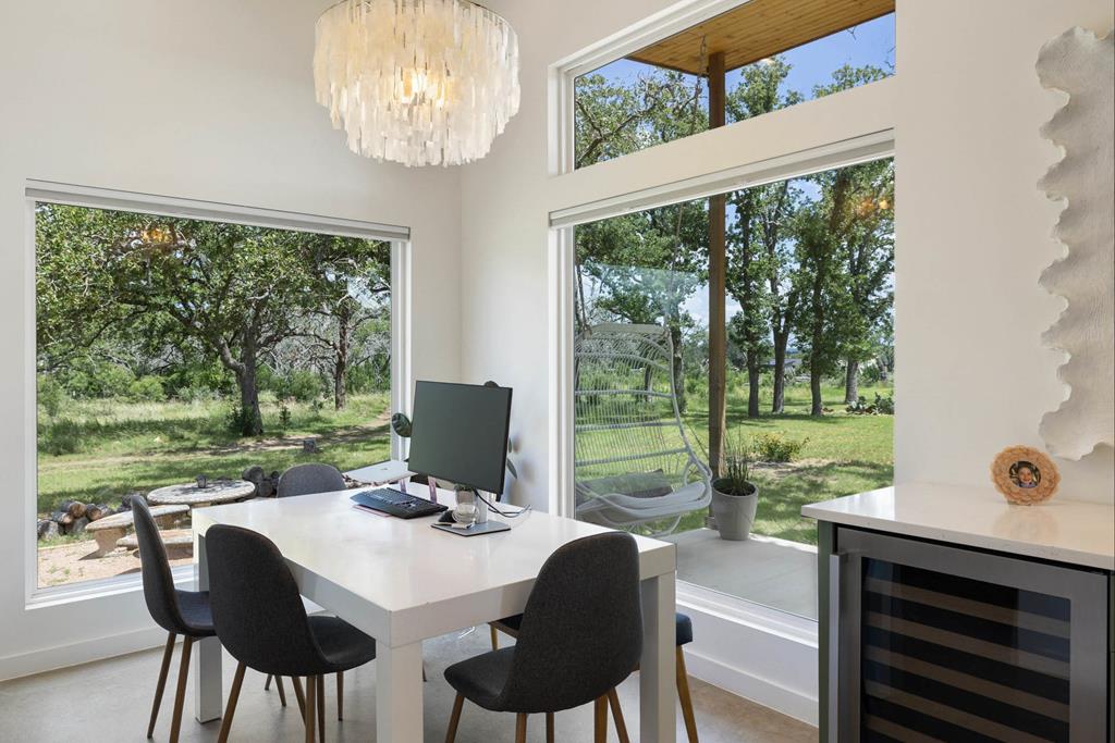 444 Klein Road Stonewall, TX 78671 - Photo 42 of 55 a view of a dining room with furniture window and outside view