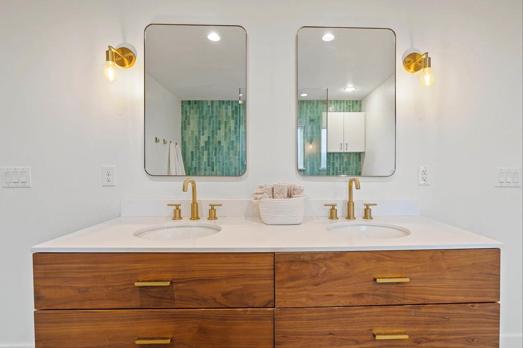 444 Klein Road Stonewall, TX 78671 - Photo 45 of 55 a bathroom with a sink and a mirror