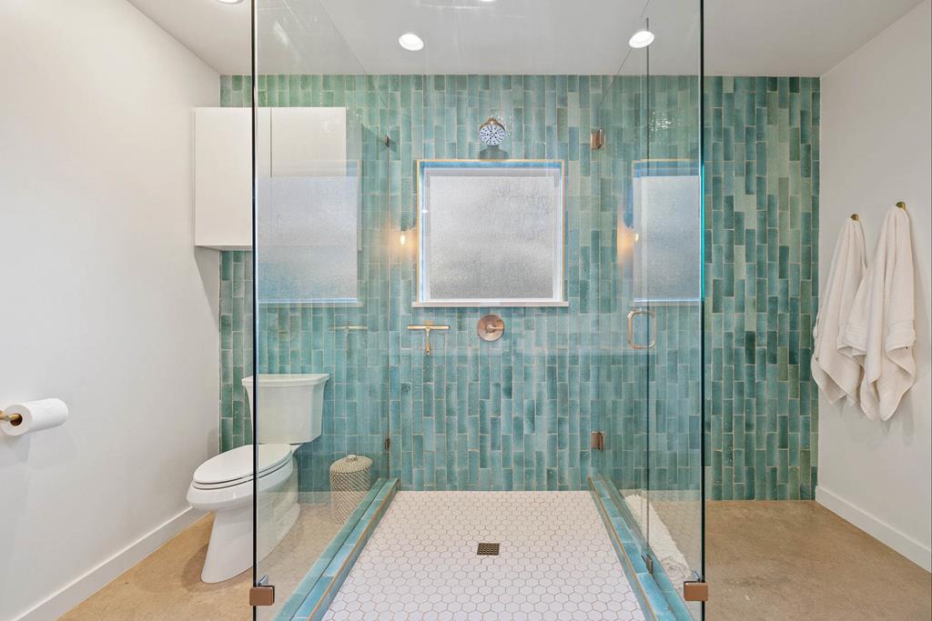 444 Klein Road Stonewall, TX 78671 - Photo 46 of 55 a bathroom with a toilet and a shower