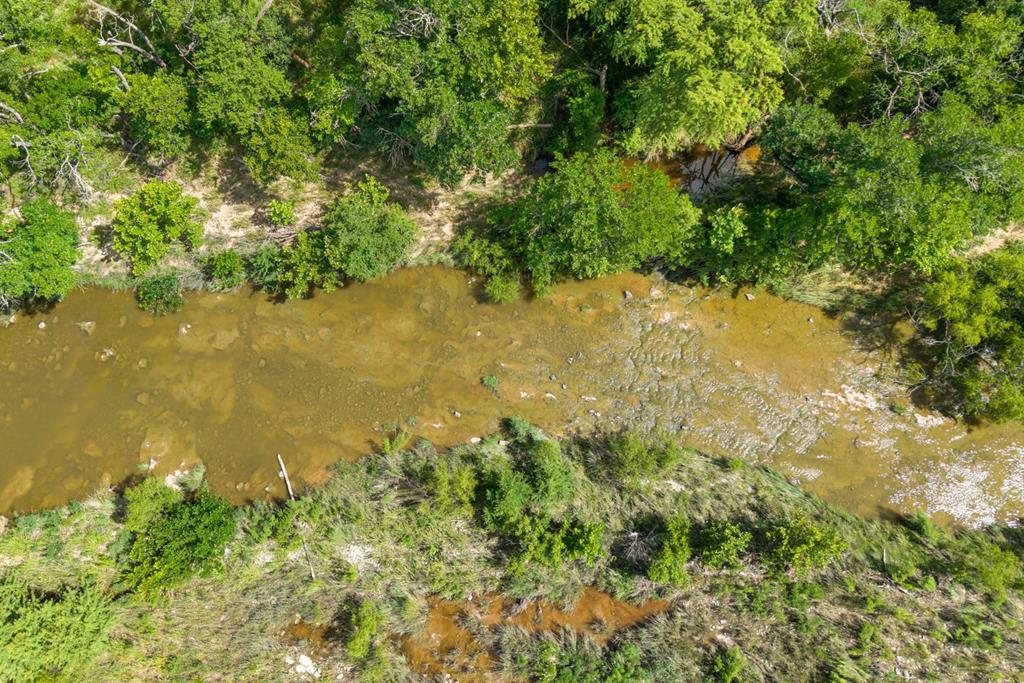 444 Klein Road Stonewall, TX 78671 - Photo 50 of 55 a view of a lake with a yard