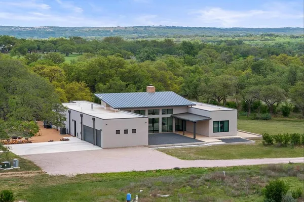 a living room with furniture a large window and stainless steel appliances