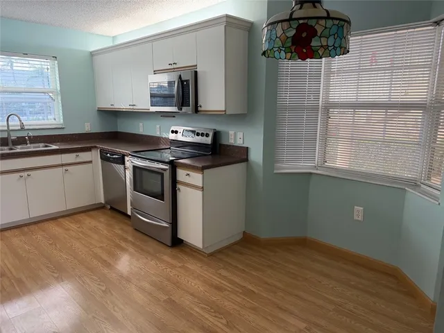 a kitchen with stainless steel appliances granite countertop a stove and a sink