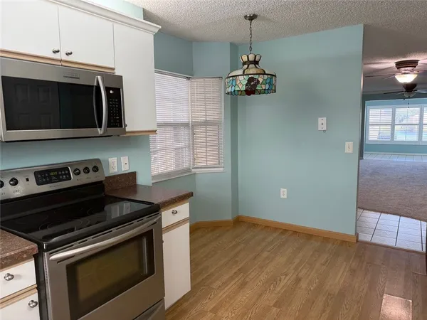 a kitchen with a stove and a microwave
