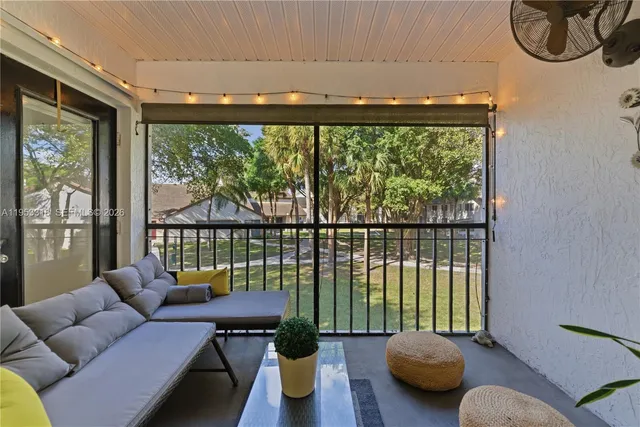 a living room with furniture and a floor to ceiling window