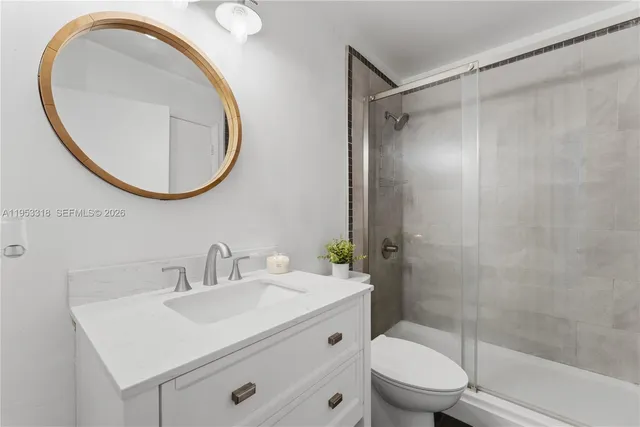 a bathroom with a sink a toilet and a mirror