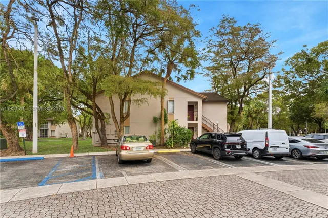 a view of car parked on the side of a street