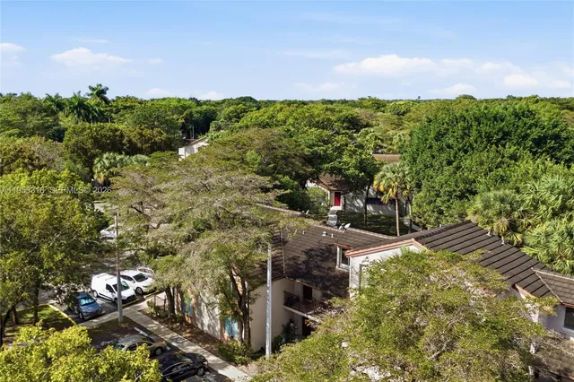 an aerial view of a houses with a yard