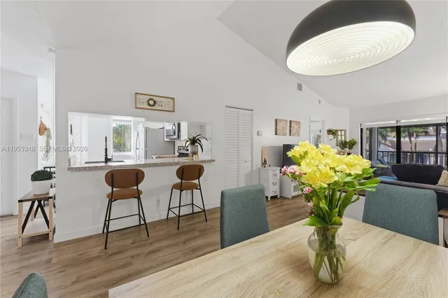 a living room with furniture flowers and a chandelier